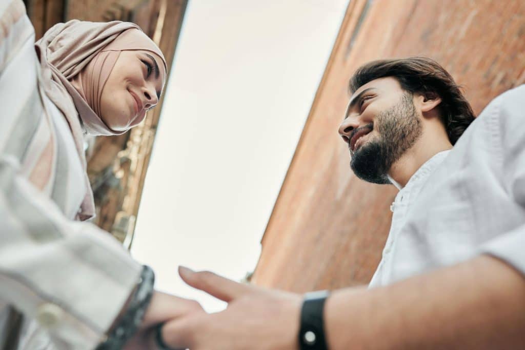 A man holding the hand of a woman