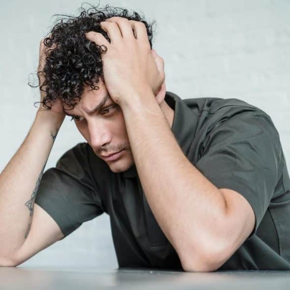 A man holding his head