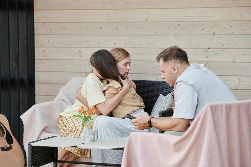 A woman hugging a kid