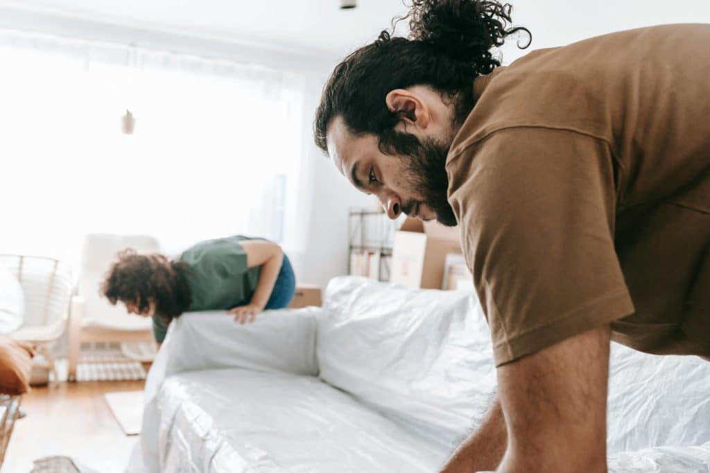 A man and woman fixing sheets