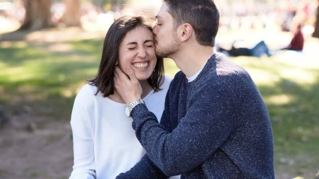 Woman laughing with visible laugh lines, husband smiling beside her