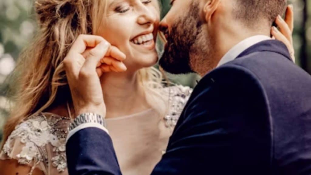 Woman with natural, slightly messy hair, laughing with husband
