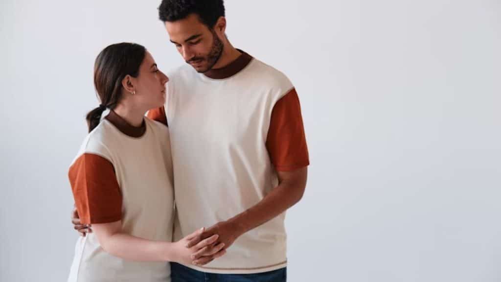 Woman that is about to rest her head on husband’s shoulder while showing emotion