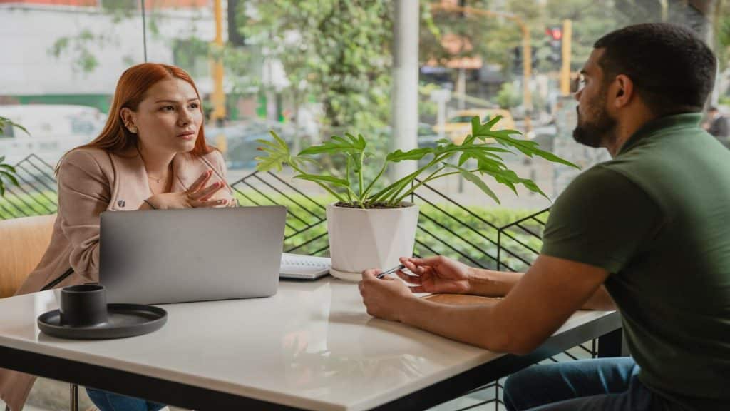 A couple talking at a cafe