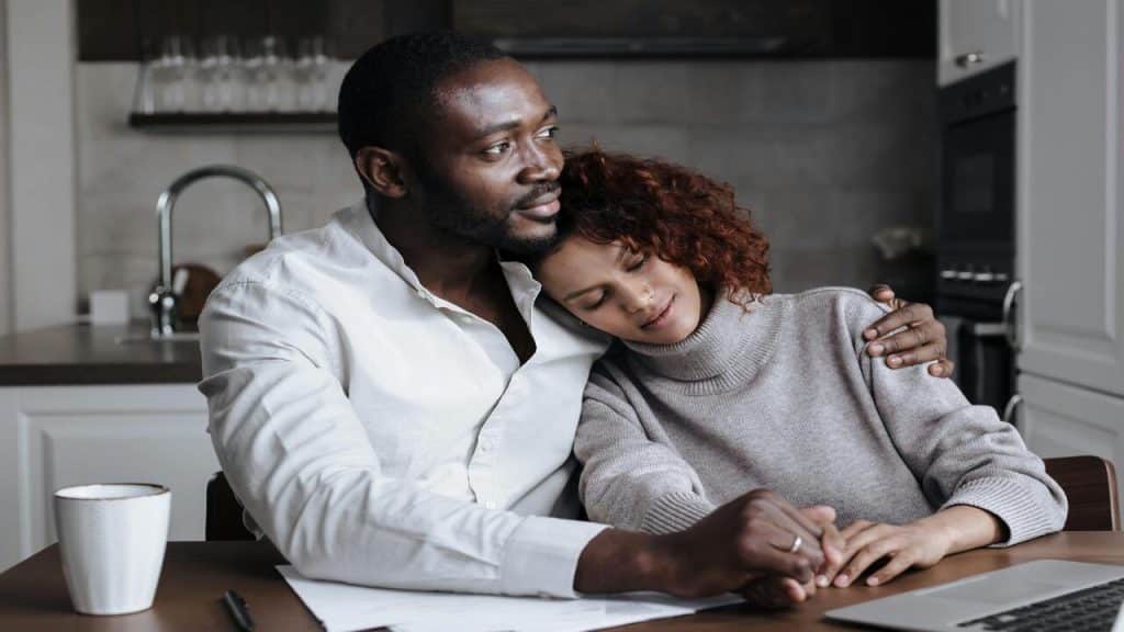 A couple hugging while sitting