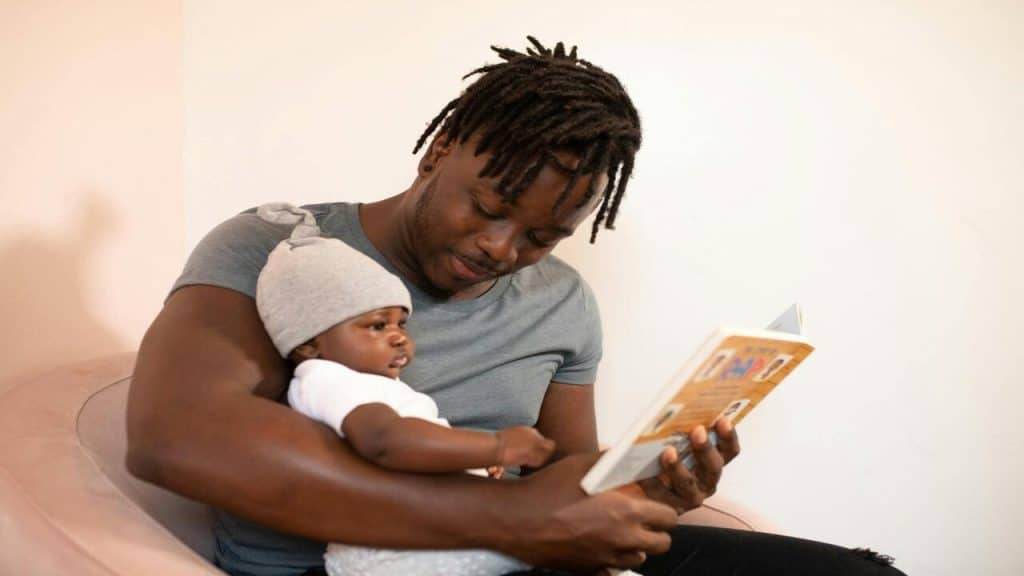 A dad reading to his baby