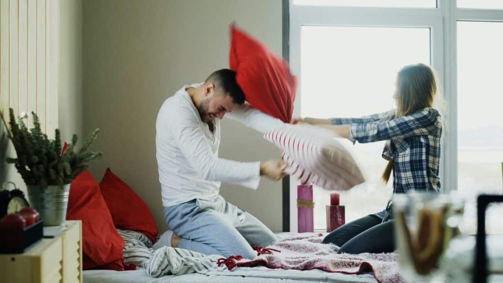 A couple having a pillow fight