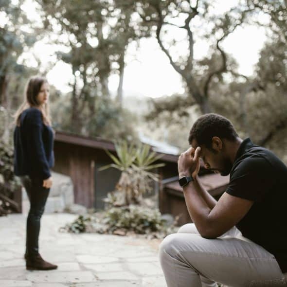A stressed man and a woman looking at him