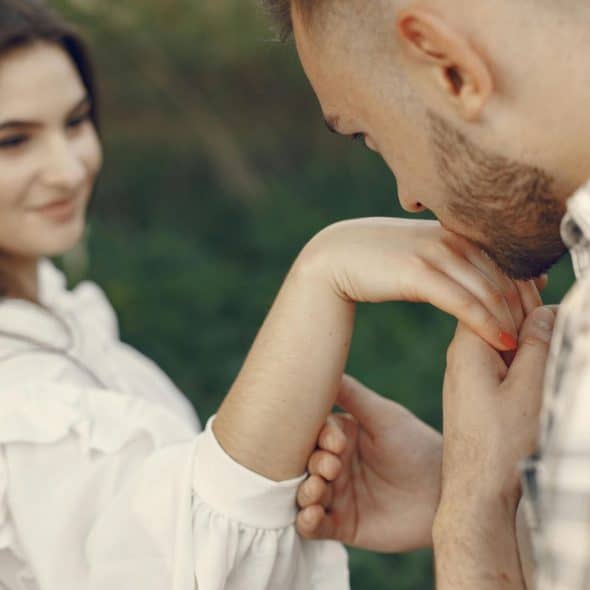 A man kissing a woman’s hand