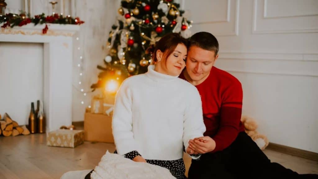 A couple celebrating an engagement during the holiday season