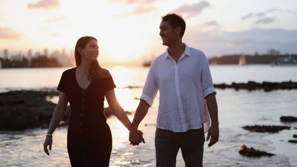 A couple walking together holding hands after engagement