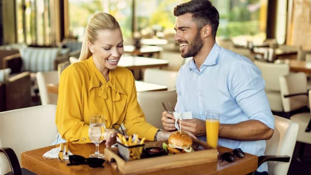 A couple laughing together at a café