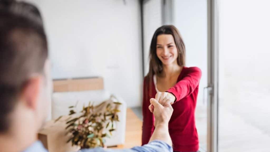 A woman confidently walks as she reaches her partner’s hand