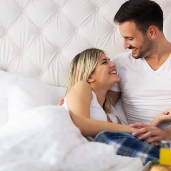 A man preparing breakfast for his wife in bed