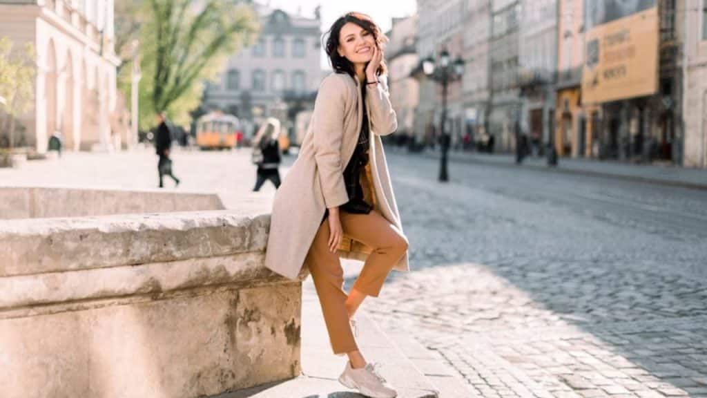 A woman wearing casual, stylish clothes, posing in the city