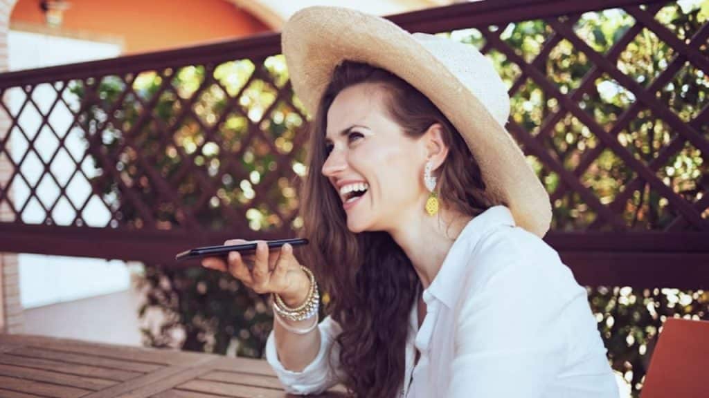 A woman calmly waits for her partner at a café table