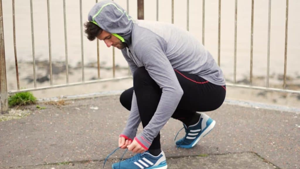 A man tying his sneakers before a morning jog