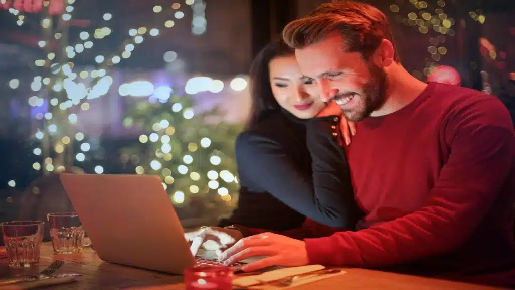 A couple looking at their laptop.