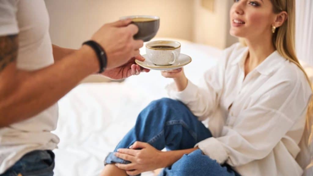 A woman alone while her partner brings her a cup of tea.