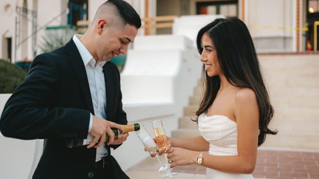 A man pouring a drink to celebrate partner success