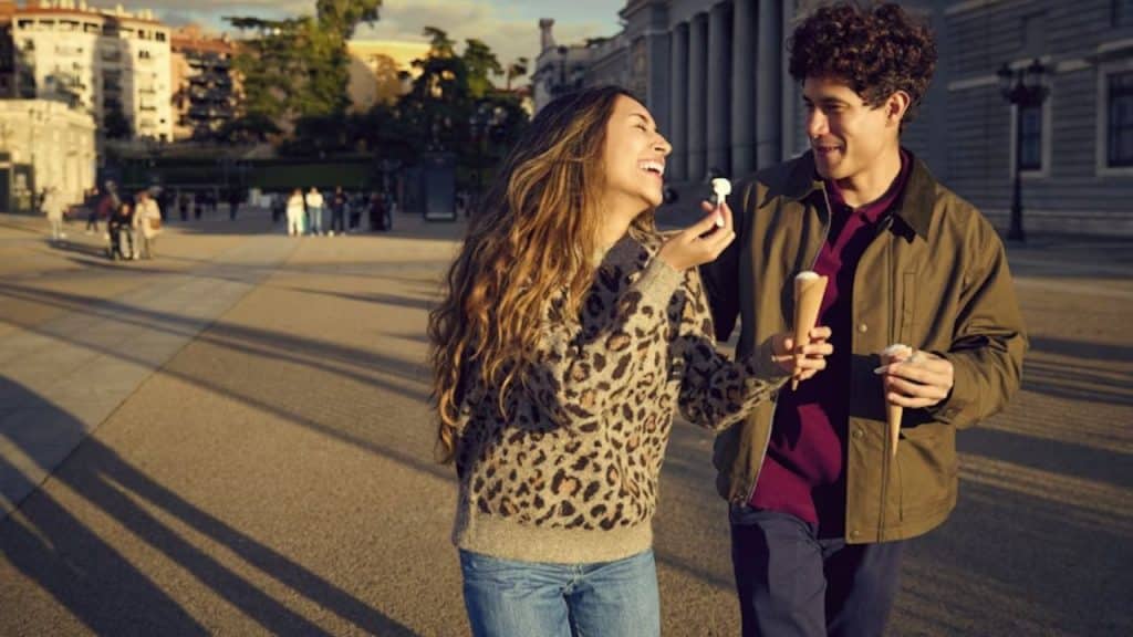 A couple laughing while walking in the city center