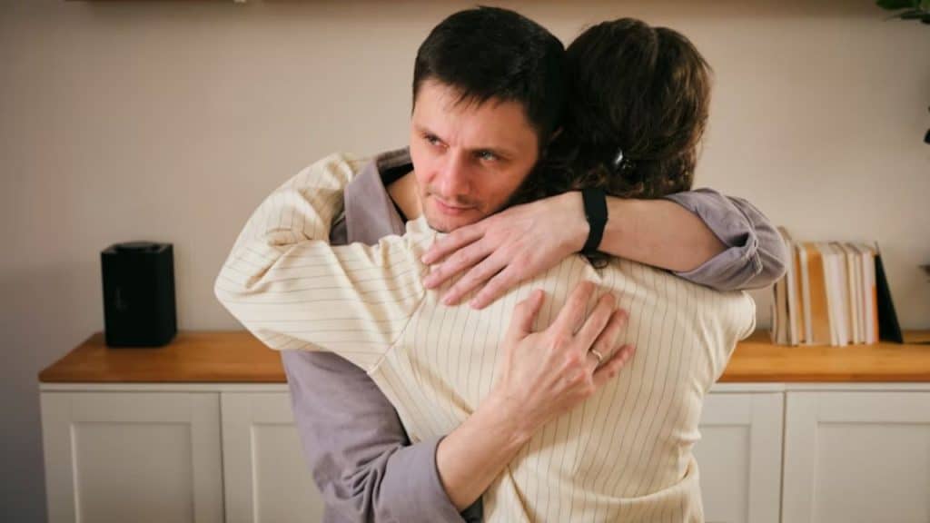 A man hugging his partner after receiving a meal