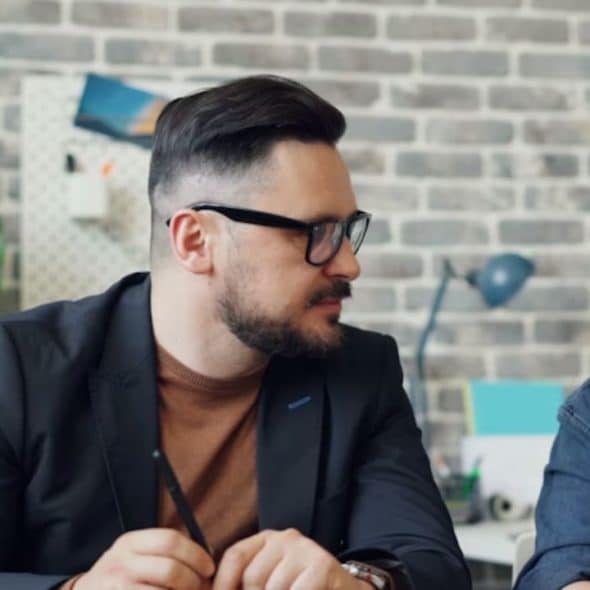 A couple sitting at a table having a heartfelt talk