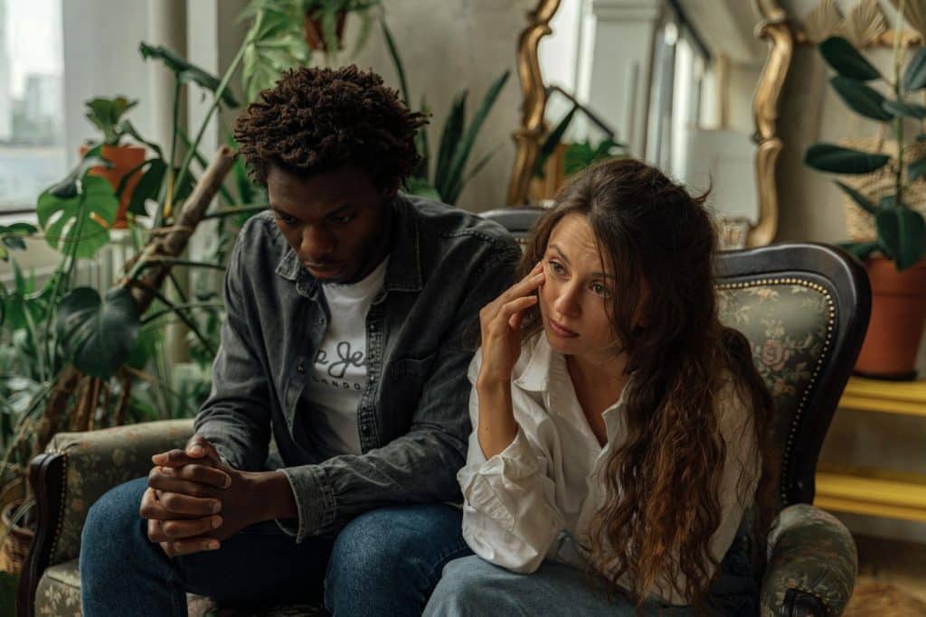 A man and woman sitting at the couch