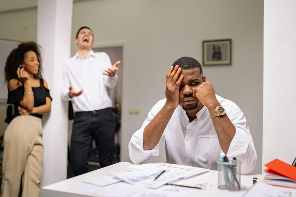 A man and woman laughing at the man