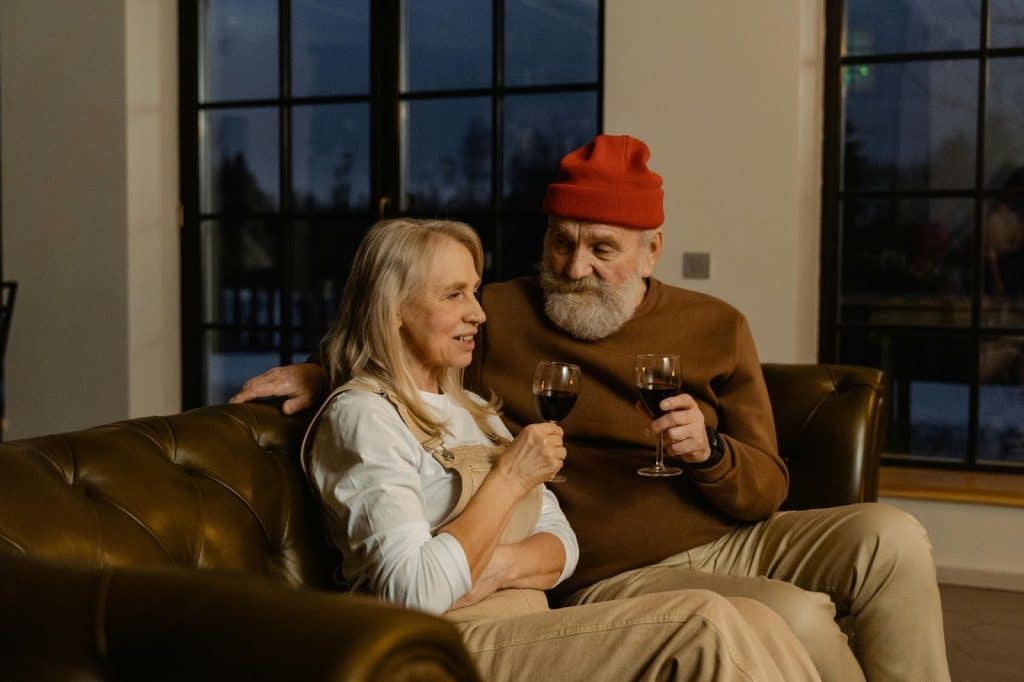 A man and woman toasting glasses of wine