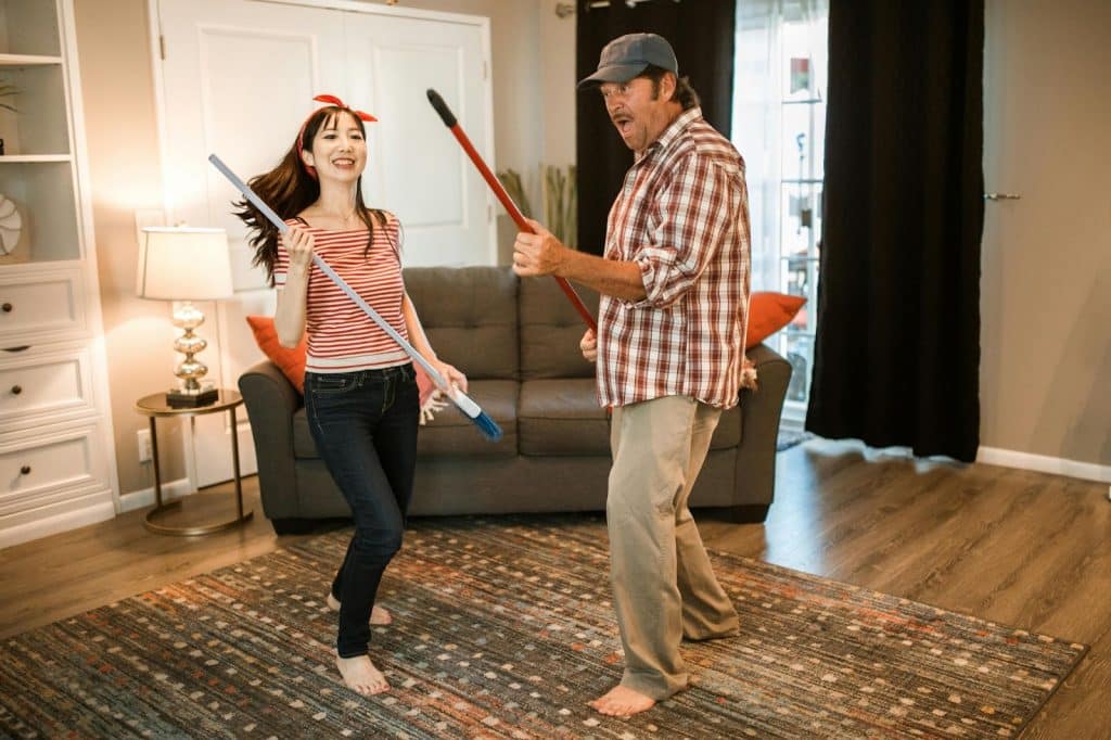 A man and woman cleaning their house