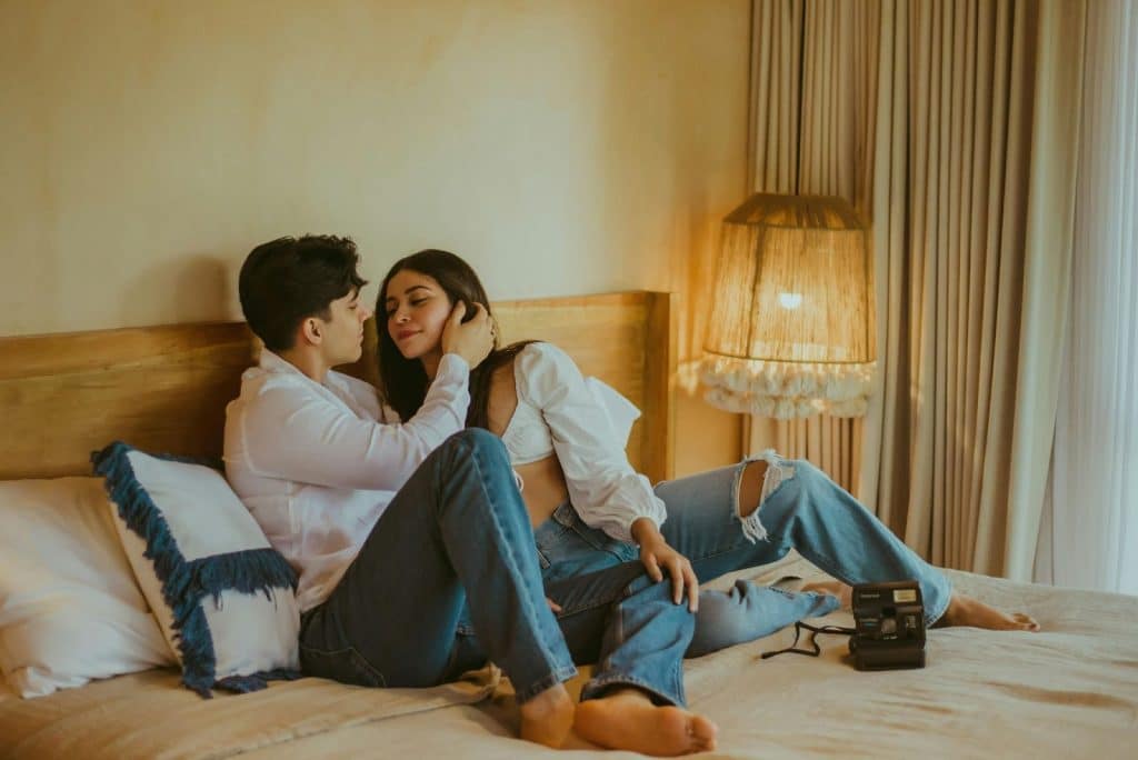A man and woman at the bed