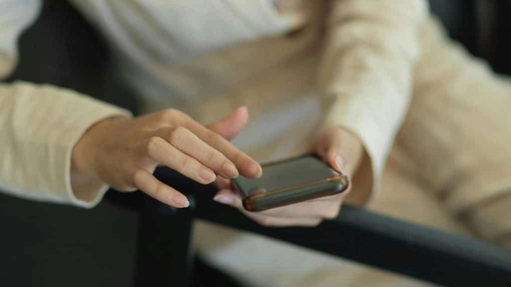 A person using a smartphone while seated.