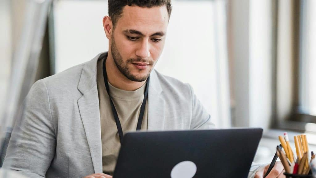 A man working on a laptop at a desk.