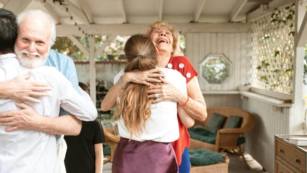 A joyful family hugging during a warm reunion.