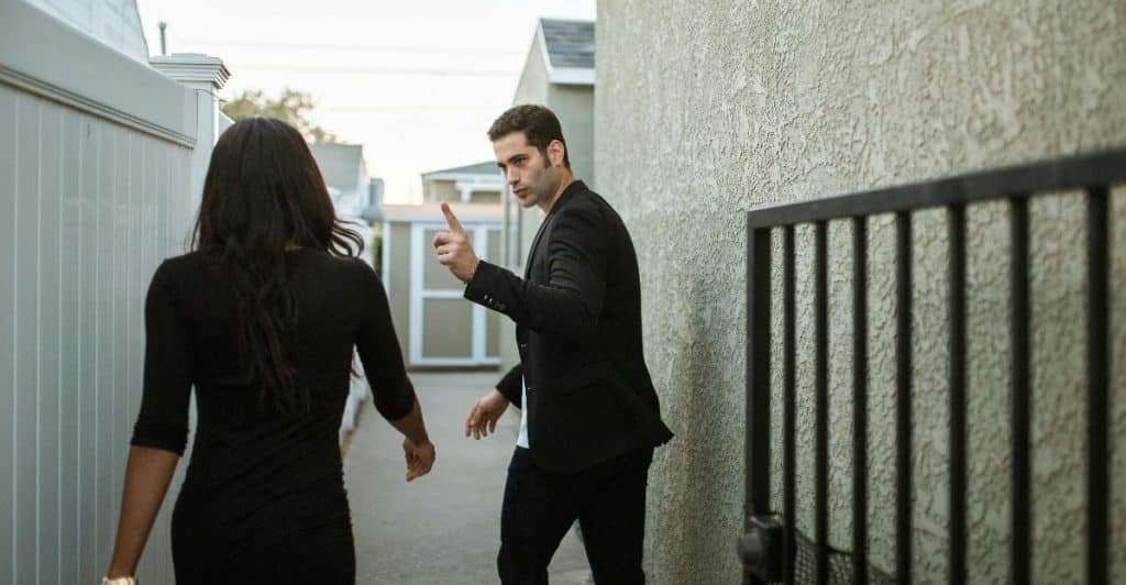 A man pointing at woman