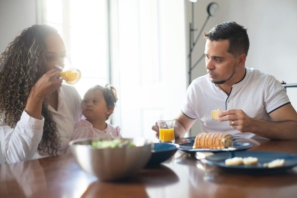 A man letting a woman to feed their baby 