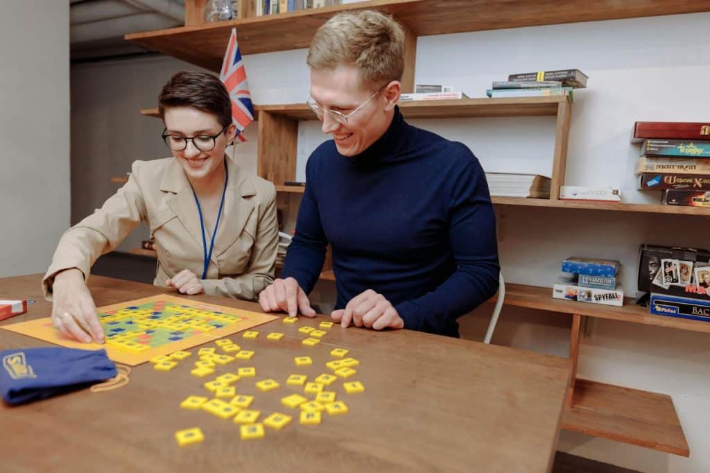 A man and women playing scrabble