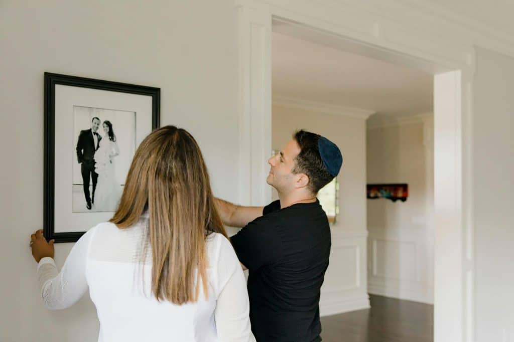 A man and woman looking at their wedding picture