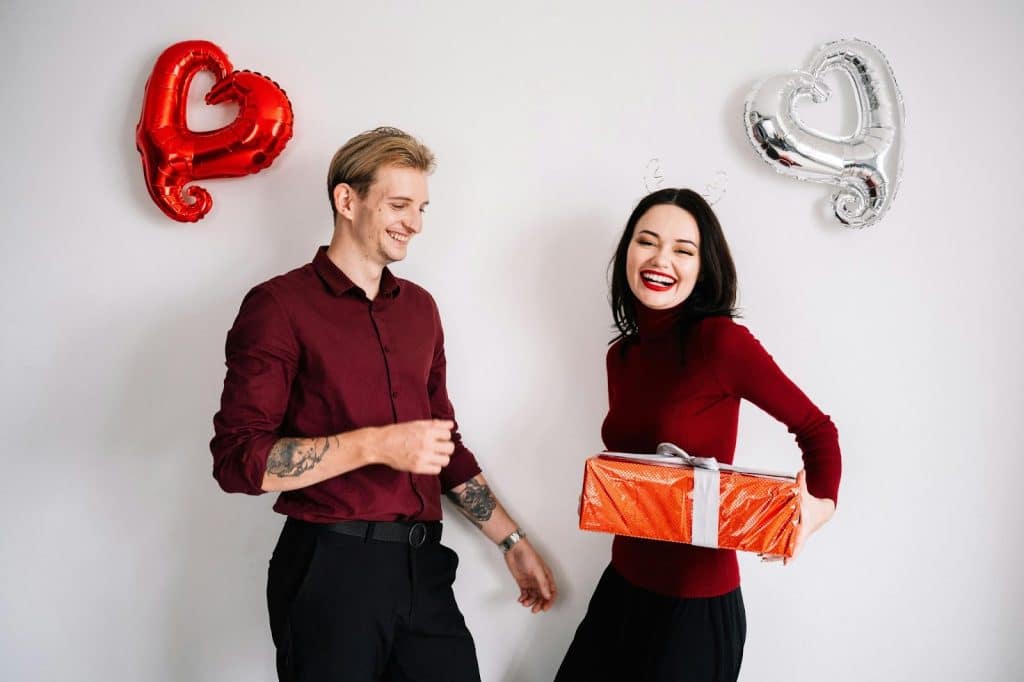 A man giving a gift to a woman