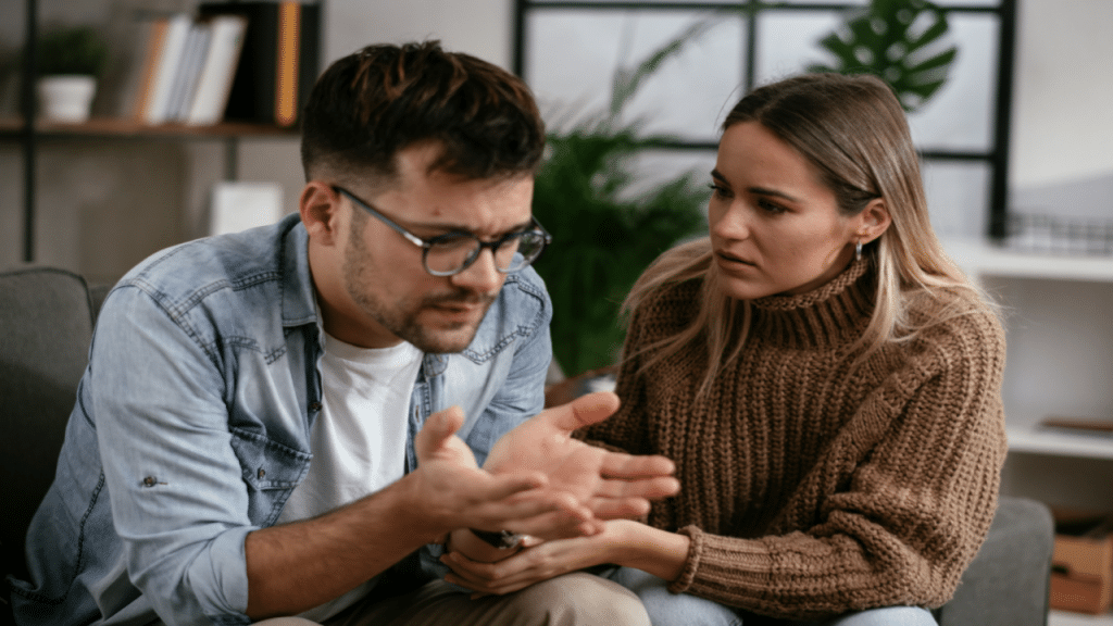 A woman comforting her sad boyfriend