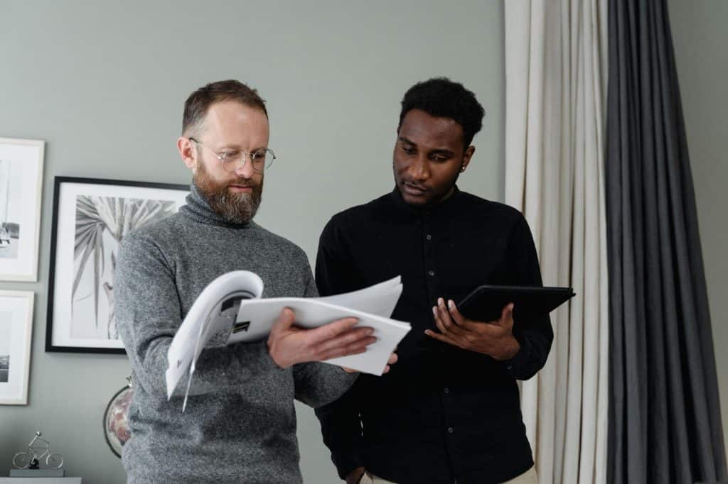 Two men checking budget 