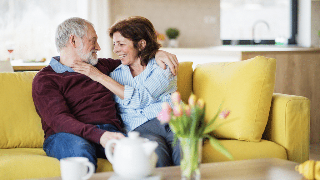 A mature couple cuddling on the couch