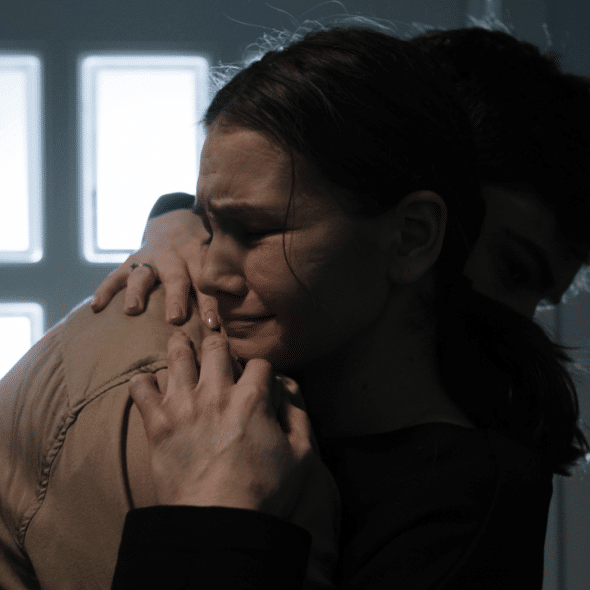A couple crying while hugging