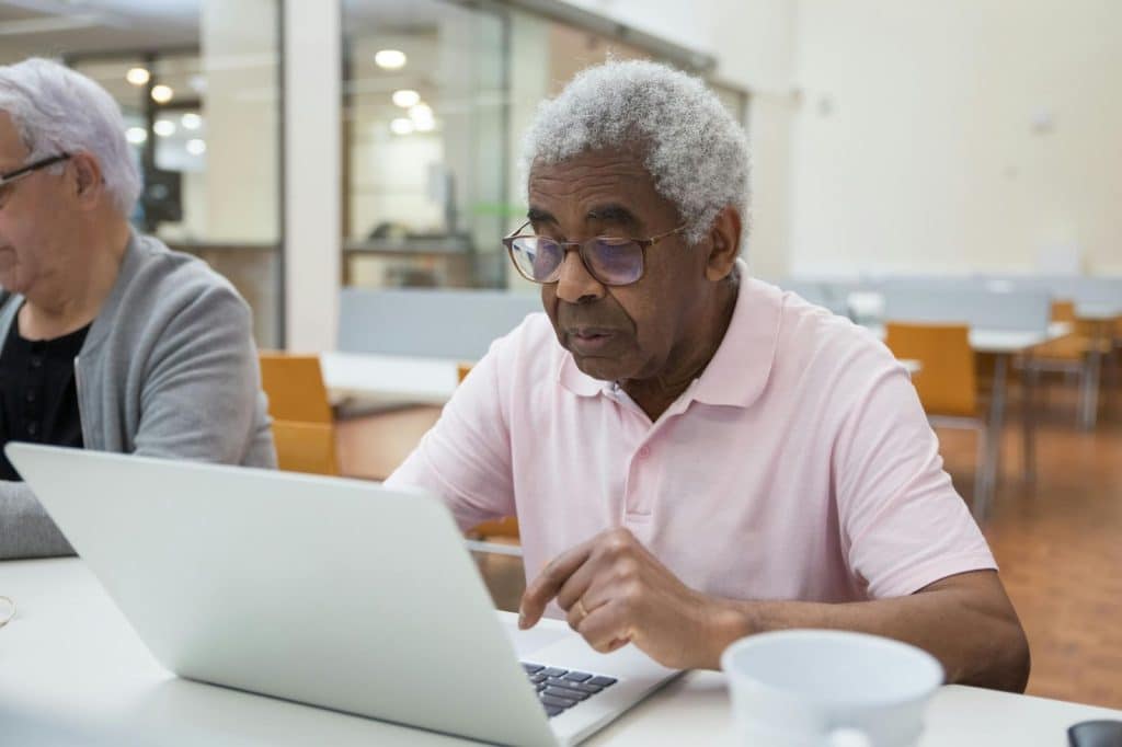 A man using a laptop learning something 
