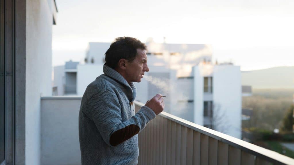 A man smoking on the balcony