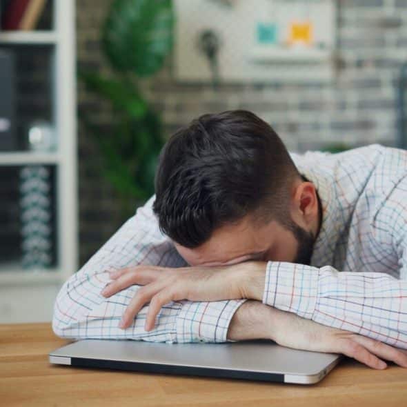 A man looking stressed at work