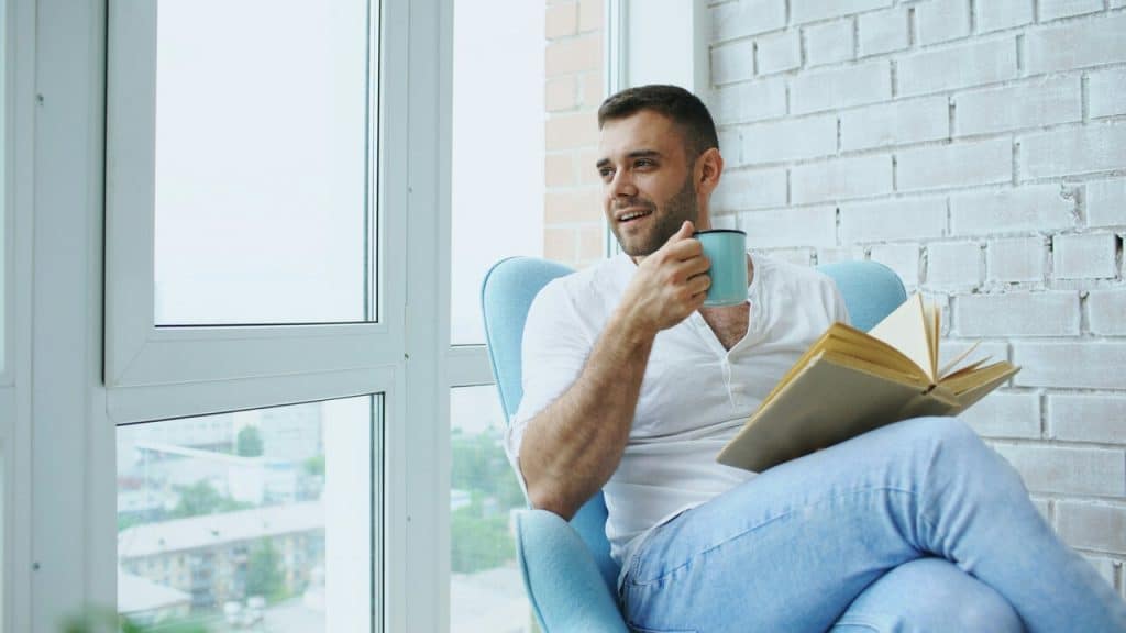 A man reading at home by himself