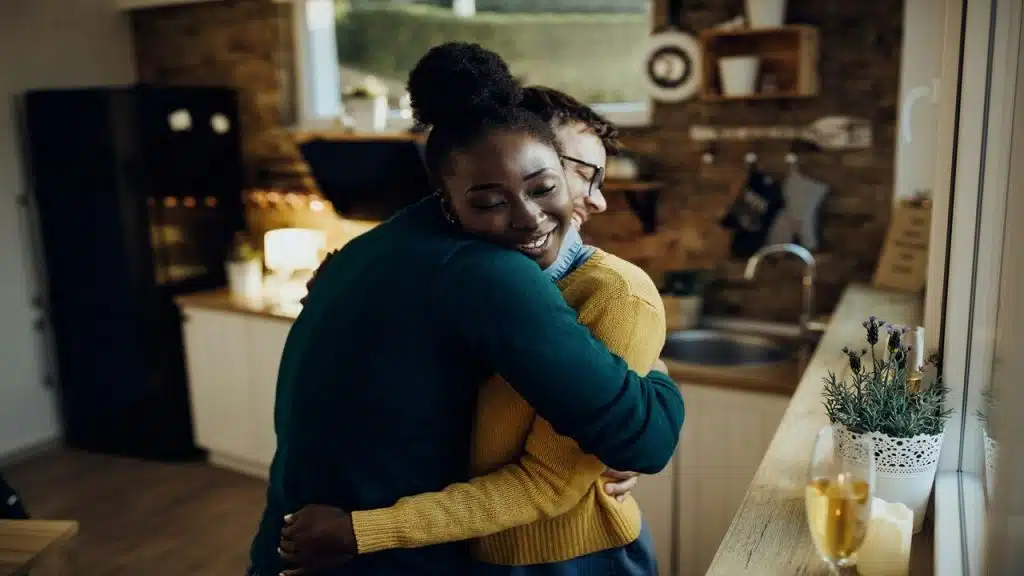 A couple hugging in the kitchen