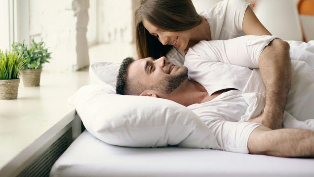 A couple talking in bed
